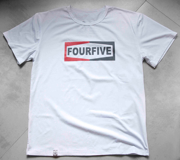 A Fourfive 45 white Champ t shirt with the Fourfive champ graphics sitting on a concrete back ground.