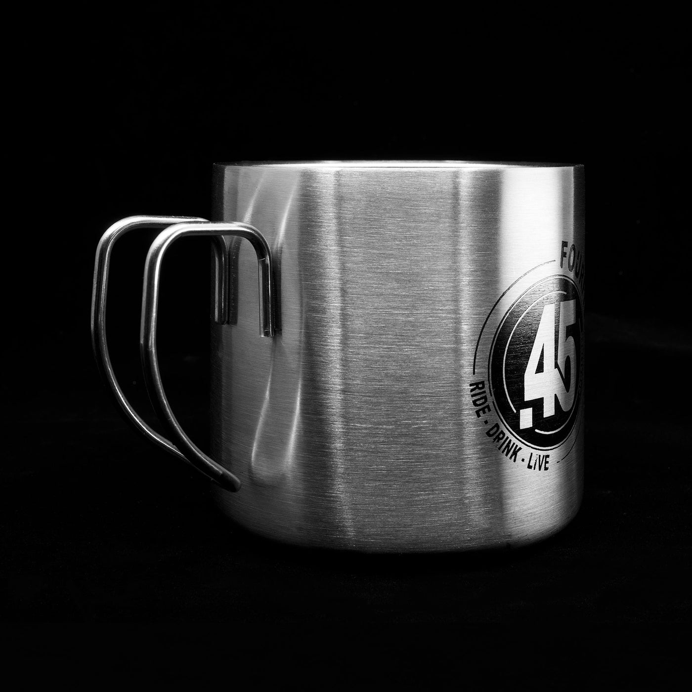 A Fourfive 45 ACP coffee mug in double walled stainless steel construction with graphics on its body facing 45 degrees to the right in black background.