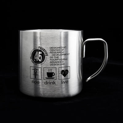 A Fourfive 45 ACP coffee mug in double walled stainless steel construction with Fourfive logo and ride drink live graphics printed on its back facing straight with a black background.
